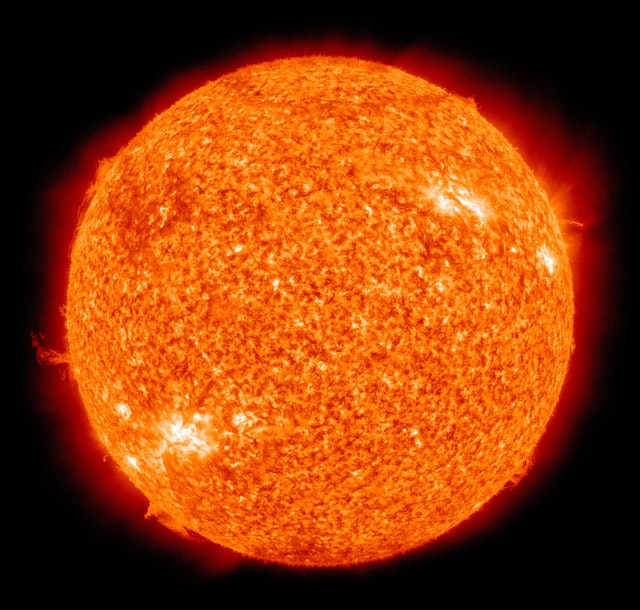 A closeup of the sun, orange with several solar flares