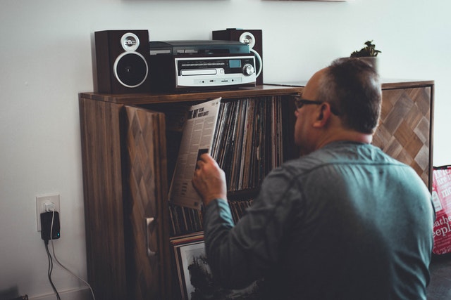 A man placing a vinyl record into his collection