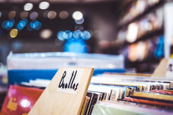 vinyl records in a record shop, with The Beatles albums front and center